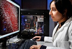 woman in lab coat at computer